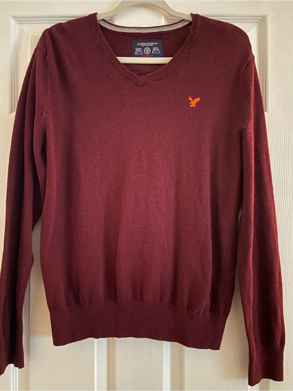 American Eagle Outfitters Men's Burgundy V-Neck Sweater with Orange Logo
